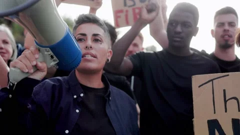 Group of  multiracial diverse people protest on the streets - Focus on nonbinary Stock Footage 237894018