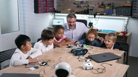 Group of multiracial kids watching at robotic car Stock Footage 225894254