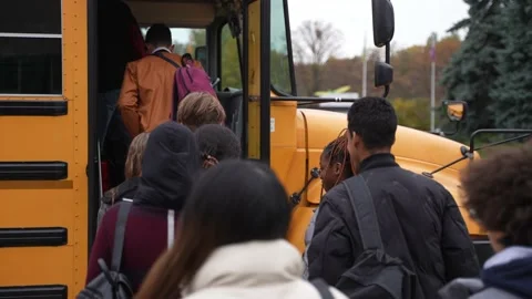 Group of multiracial students entering school bus Stock Footage 169654998