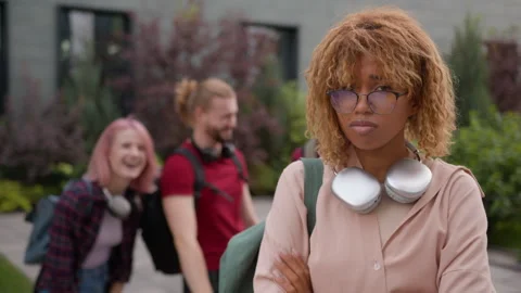 Group of multiracial students friends classmates bully African American student Stock Footage 250548155