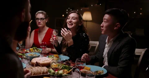 Group of multiracial students having a dinner party. People sitting at table Stock Footage 137250251