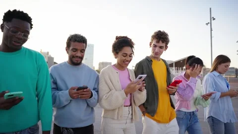 A group of multiracial young people walking using mobile cell Stock Footage 271602774