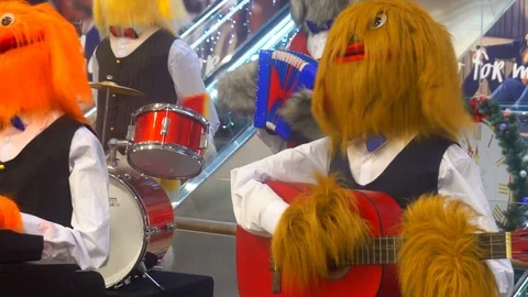 A group of musicians in the form of large soft toys, play various musical Stock Footage 84912236
