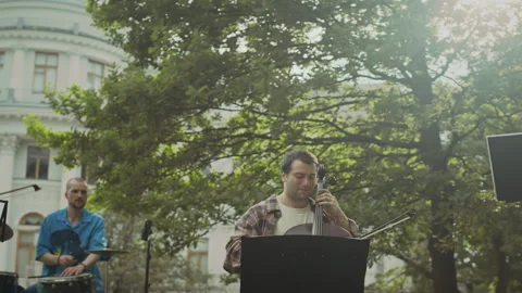 Group of Musicians Playing Classical Instruments on Rehearsal in Park Stock Footage 280675767