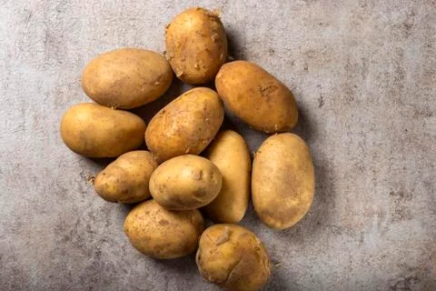 Group of new potatoes on a rustick background Stockfoto's