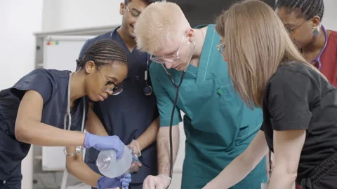 Group of nurses performing first aid on baby dummy Stock-Footage 272227305