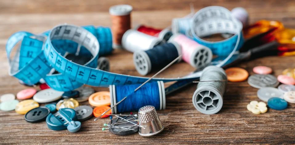 Group of objects about Sewing equipment set on a wooden background. Sewing and Stock Photos