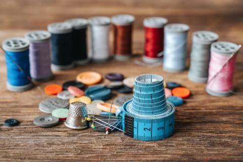 Group of objects about Sewing equipment set on a wooden background. Sewing and Stock Photos