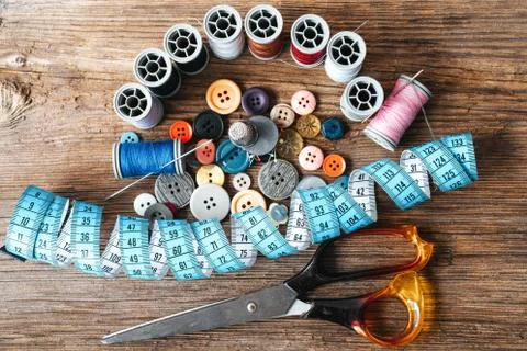 Group of objects about Sewing equipment set on a wooden background. Sewing and Stock Photos