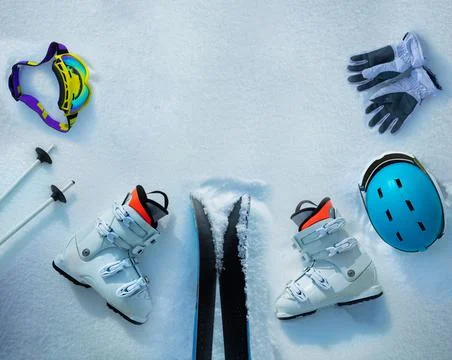 Group of objects ski boots, helmets, masks in the snow Stock Photos