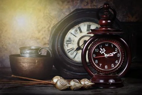 Group of objects on wood table. old clock, antique wooden clock ,Still life Stock Photos