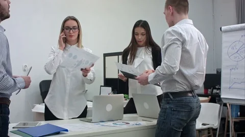 Group of office workers with diagrams preparing for business presentation 스톡 동영상 71603622