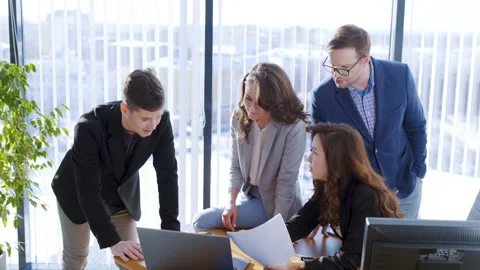 Group of office workers discussing strategy plan for presentation. Colleagues Stock Footage 152453213