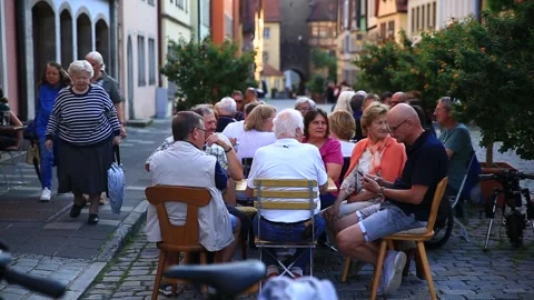 Group of old tourists dining out on the old town street, Rothenburg, Germany Video stock 284463010