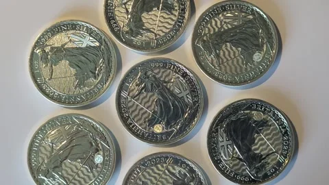 Group of one ounce solid silver UK Britannia coins rotate Stock Footage 245501474