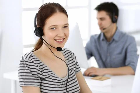 Group of operators at work. Call center. Focus on beautiful woman receptionist Stock Photos