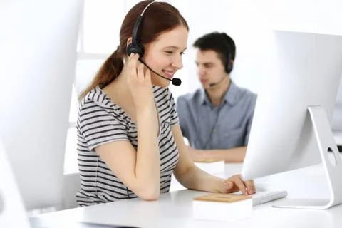 Group of operators at work. Call center. Focus on beautiful woman receptionist Stock Photos