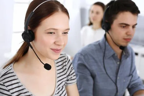 Group of operators at work. Call center. Focus on beautiful woman receptionist Stock Photos