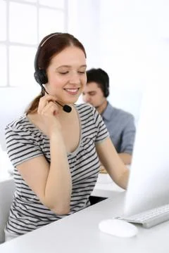 Group of operators at work. Call center. Focus on beautiful woman receptionist Stock Photos
