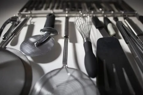 Group of Organized Kitchen Tools Hanging on Home Kitchen Wall 스톡 사진