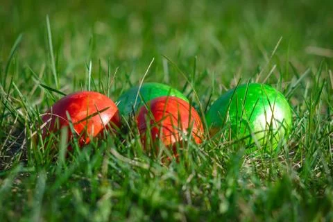 Group of painted easter eggs on the bright spring grass. Easter hunt Stock Photos