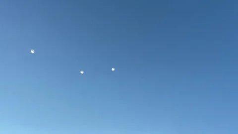 A group of parachutists floating in the sky as seen from below. Stock Footage 201291257