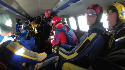 Group of parachutists sits inside a small plane awaiting a jump. Slow Motion Video stock 96546738