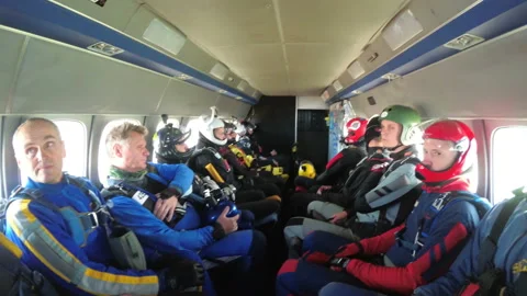 Group of parachutists sits inside a small plane awaiting a jump. Slow Motion Video stock 96579463
