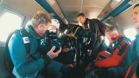 Group of parachutists sits inside a small plane awaiting a jump. Slow Motion Video stock 96580090