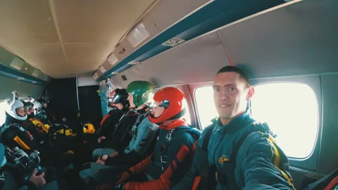 Group of parachutists sits inside a small plane awaiting a jump Stock Footage 96597308