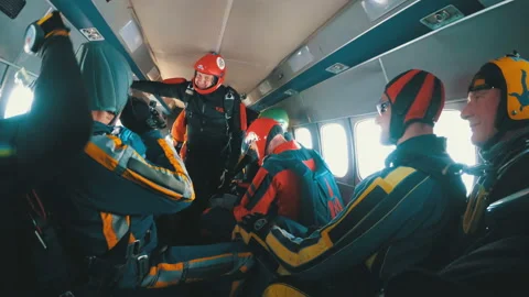 Group of parachutists sits inside a small plane awaiting a jump Stock Footage 96607539