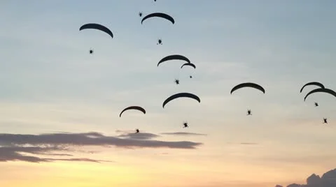 Group of paraglider or paramotor activity fly with beautiful sunset background Stock Footage 12119952