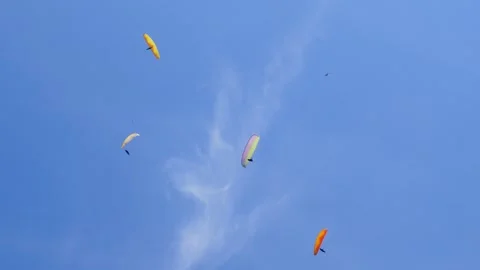 Group of Paragliders Flying on the Background of the Blue Sky Stock Footage 243940910