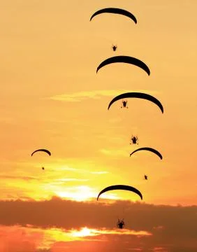 Group of paragliding on the sunset background Stock Photos