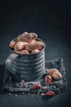Group of peanuts with in old rustic metal mug Stock Photos