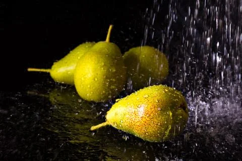 Group of pears with falling water drops Stock Photos