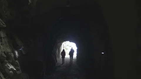 Group of people are  getting out from the tunnel in the mountain Stock Footage 89619627