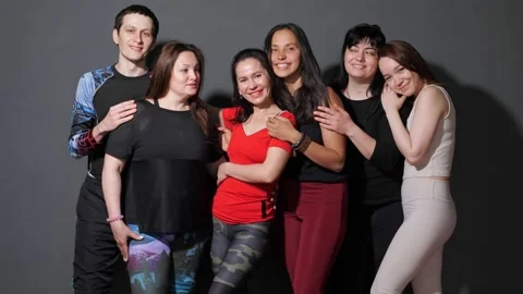 Group of people are standing leaning against the wall, smiling, pose for the Stock Footage 154996826
