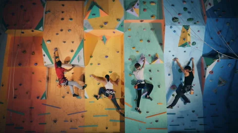 Group of people are taking part in a clambering practice in a gym Stock Footage 99248520