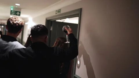 A group of people are walking down a hallway Stock Footage 295996962