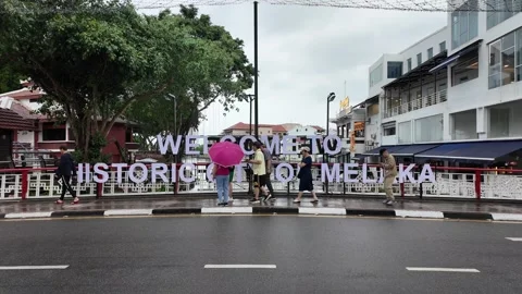 A group of people are walking down a street 스톡 동영상 318098741
