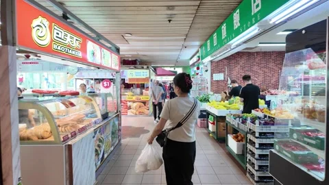 A group of people are walking through a food court 動画素材 317006446
