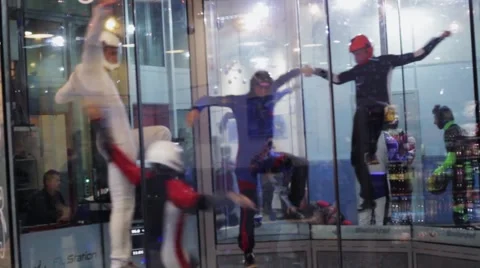 Group of people balance inside fly station. Simulator skydiving. Contest. Team Stock Footage 67558159