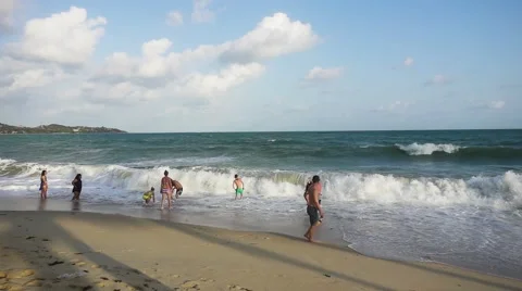 A Group of People Bathing in Stormy Waves on the Beach. Slow Motion Stock Footage 58696265