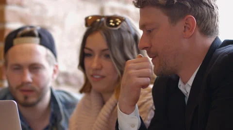 Group of people in the cafe at the table. People talk and drink coffee. Video stock 66949890