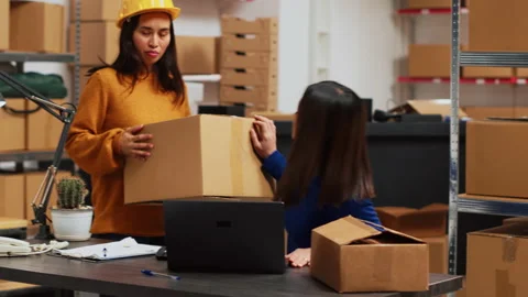 Group of people checking products in boxes Stock Footage 236430951