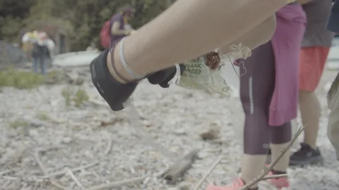 Group people cleaning up the beach with plastic bags full of garbage. Stock Footage 127894304