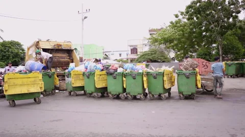 Group of people collaborate to loading trash from plastic recycle container to t Stock Footage 248090059