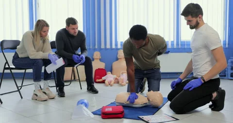 Group of people CPR First Aid Training course. CPR teen dummy first aid training Stock Footage 163979553
