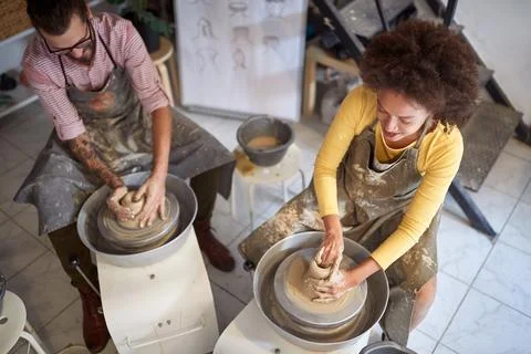 Group of people creative handmade workshop. Wet clay on wheel. Creative, ho.. Stock Photos